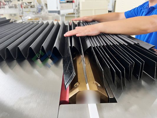 How should the material of the protective cover be selected to adapt to different environments